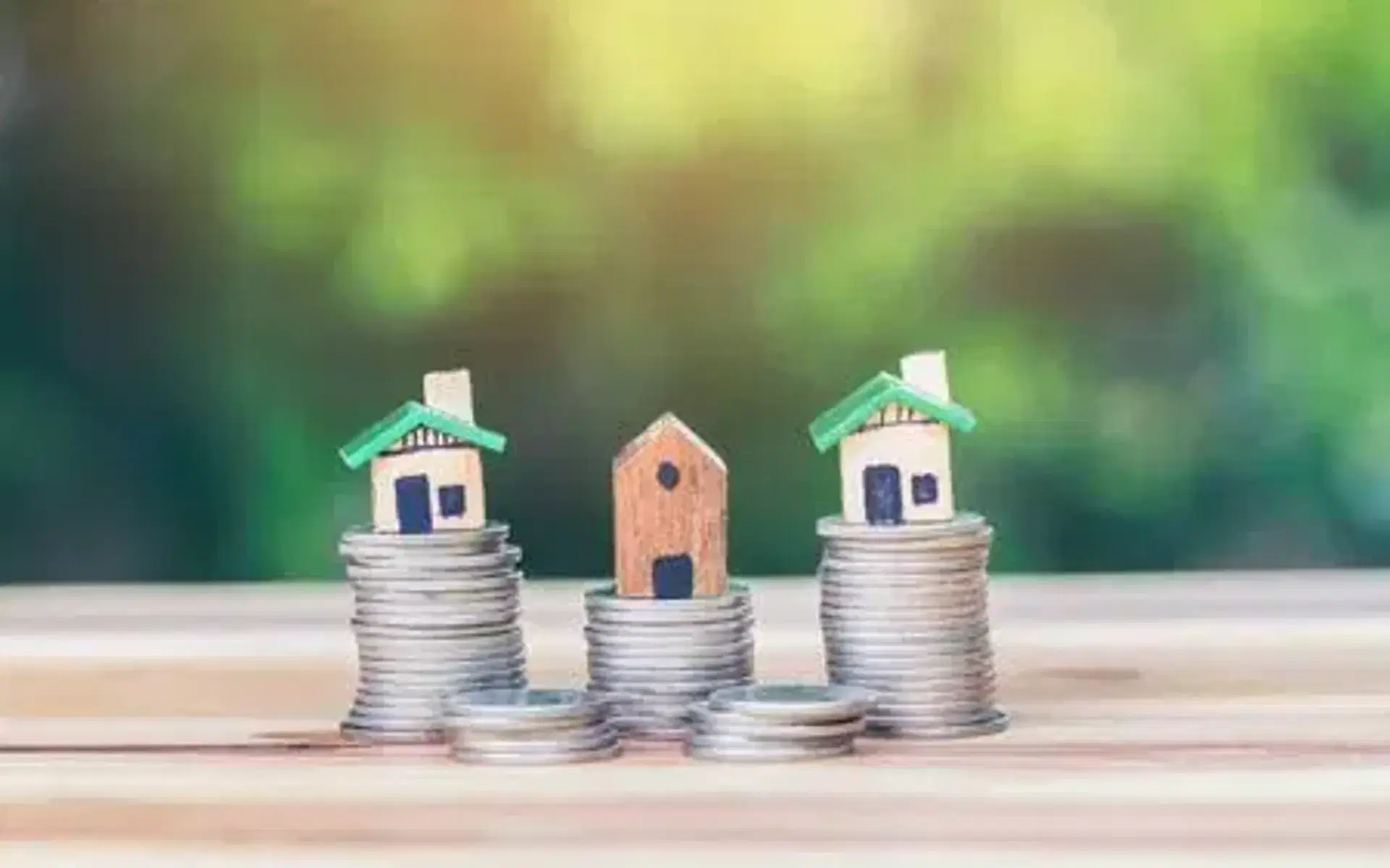 Houses placed on stacks of coins
